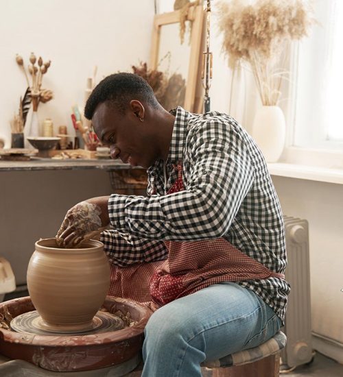 cheerful-man-working-on-new-clay-vessel-resize.jpg